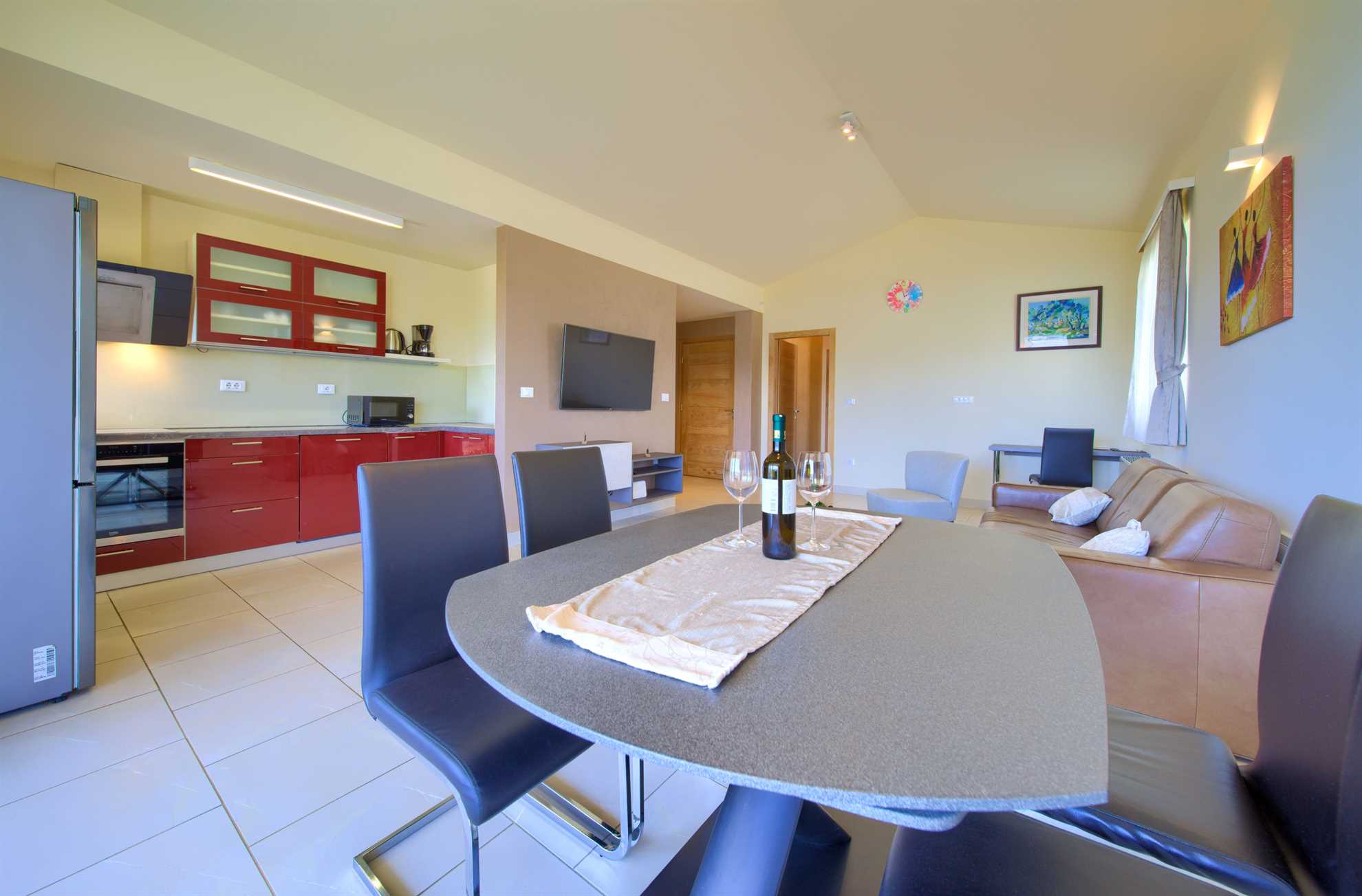 Apartment room featuring a kitchen, dining area and living room