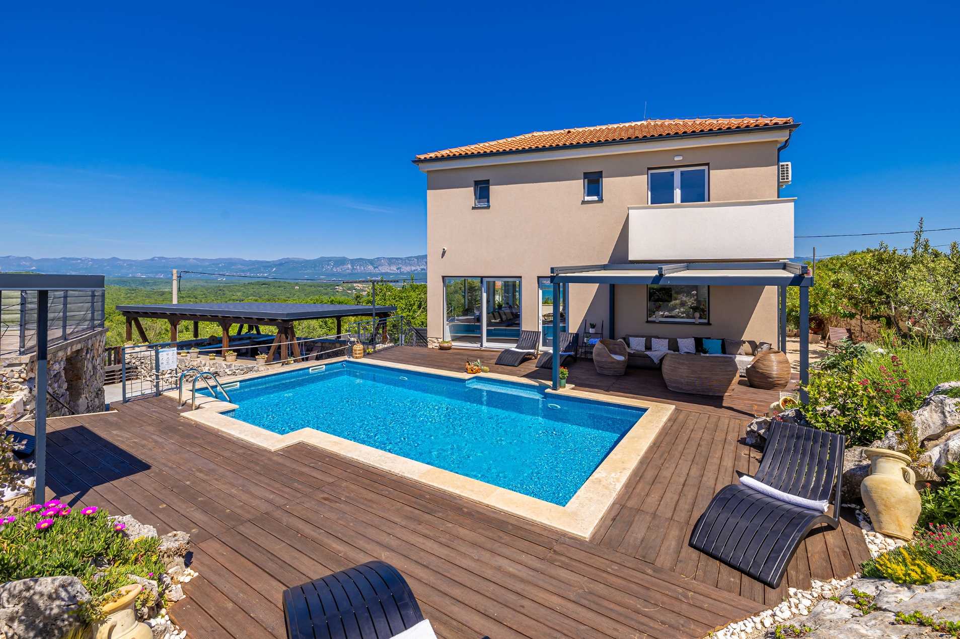 Villa Bella Vista with a private pool in a landscaped garden surrounded by greenery.