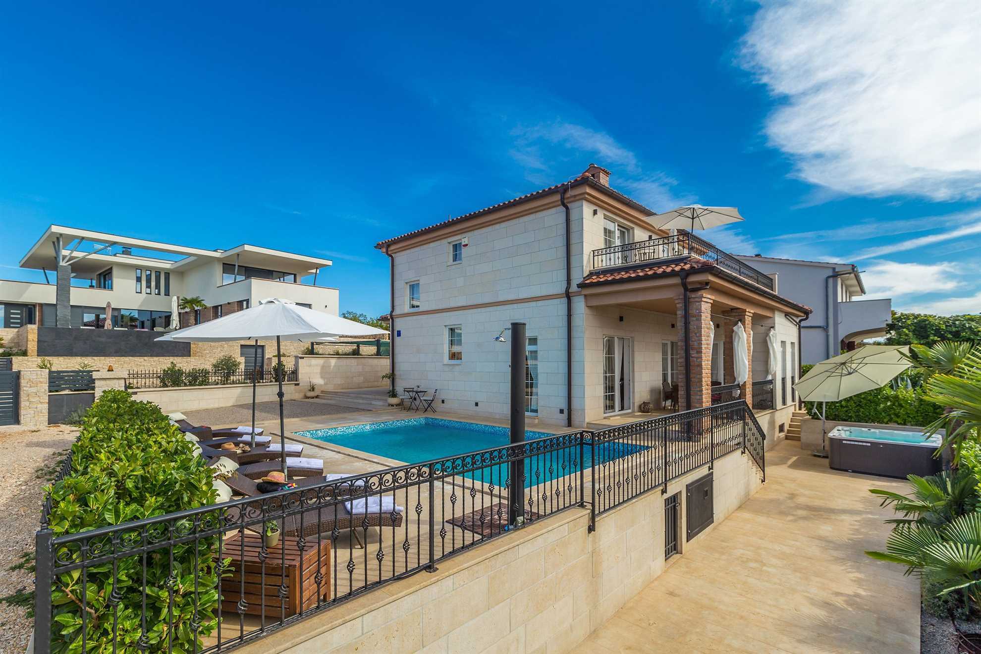 Luxury vacation home with a swimming pool and a jacuzzi.