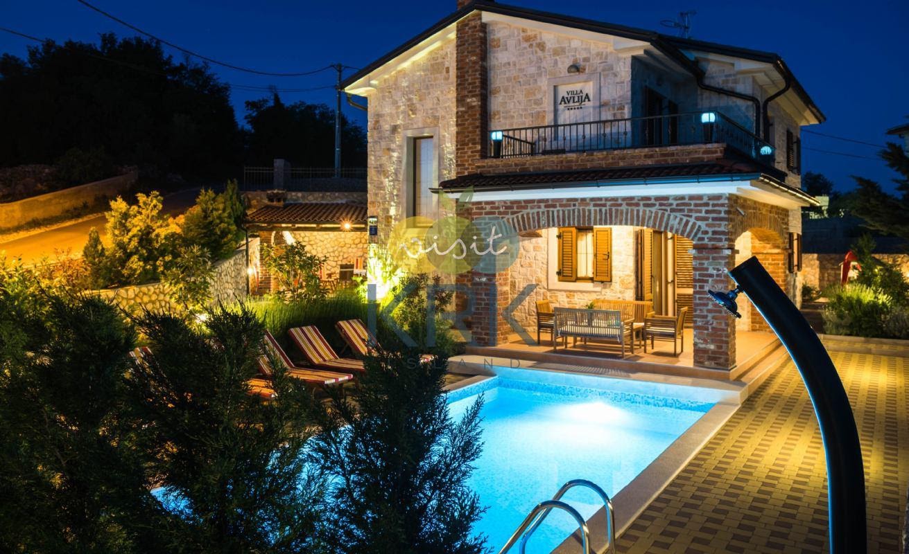 Luxury villa with a pool in a nighttime ambiance.