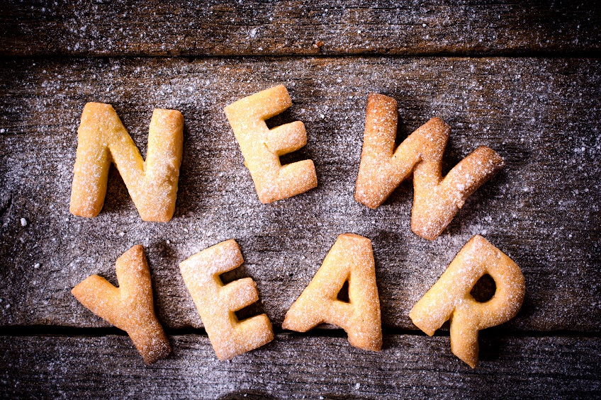 Letter-shaped cakes spelling "New Year", sprinkled with powdered sugar.