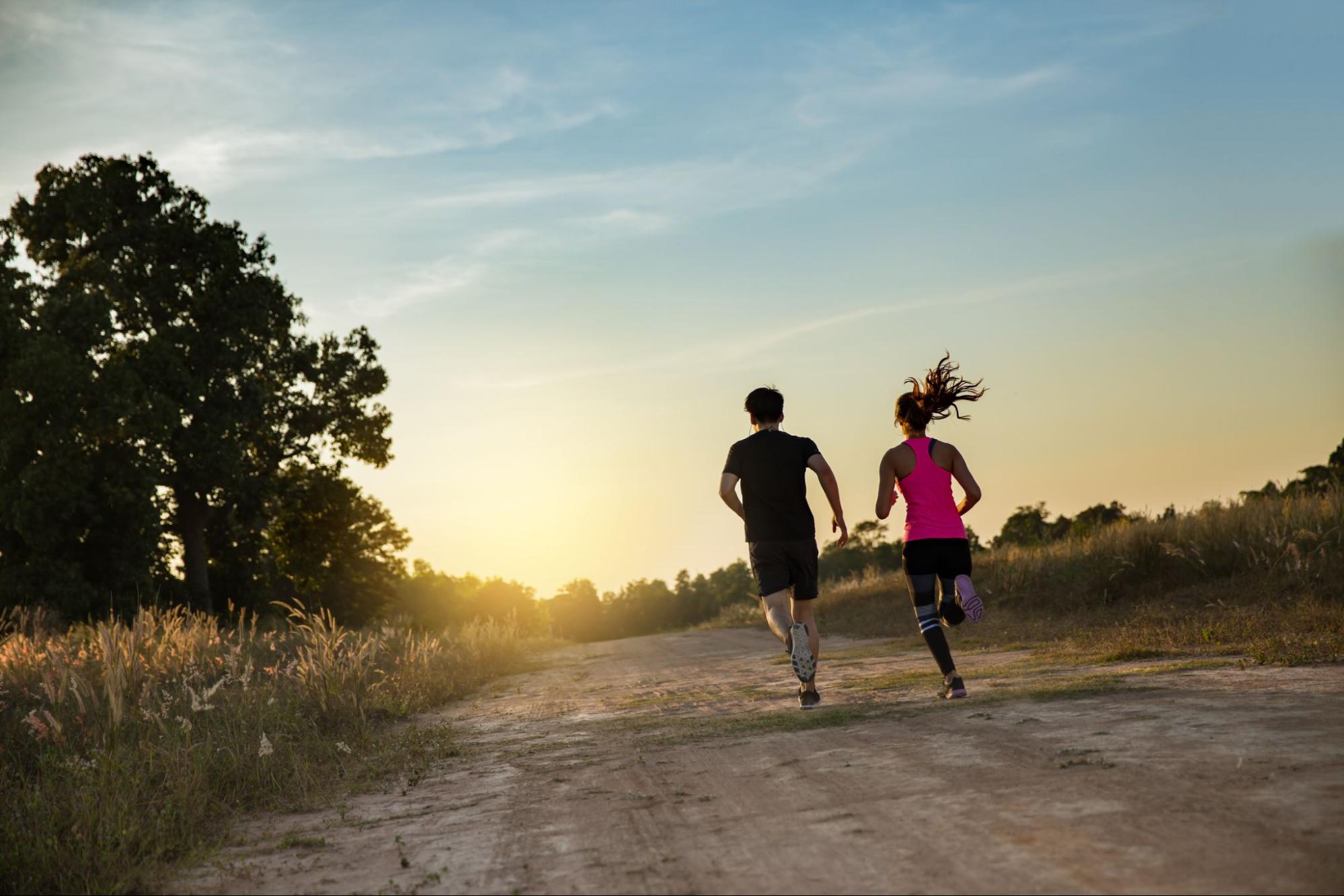 Young couple running in nature.