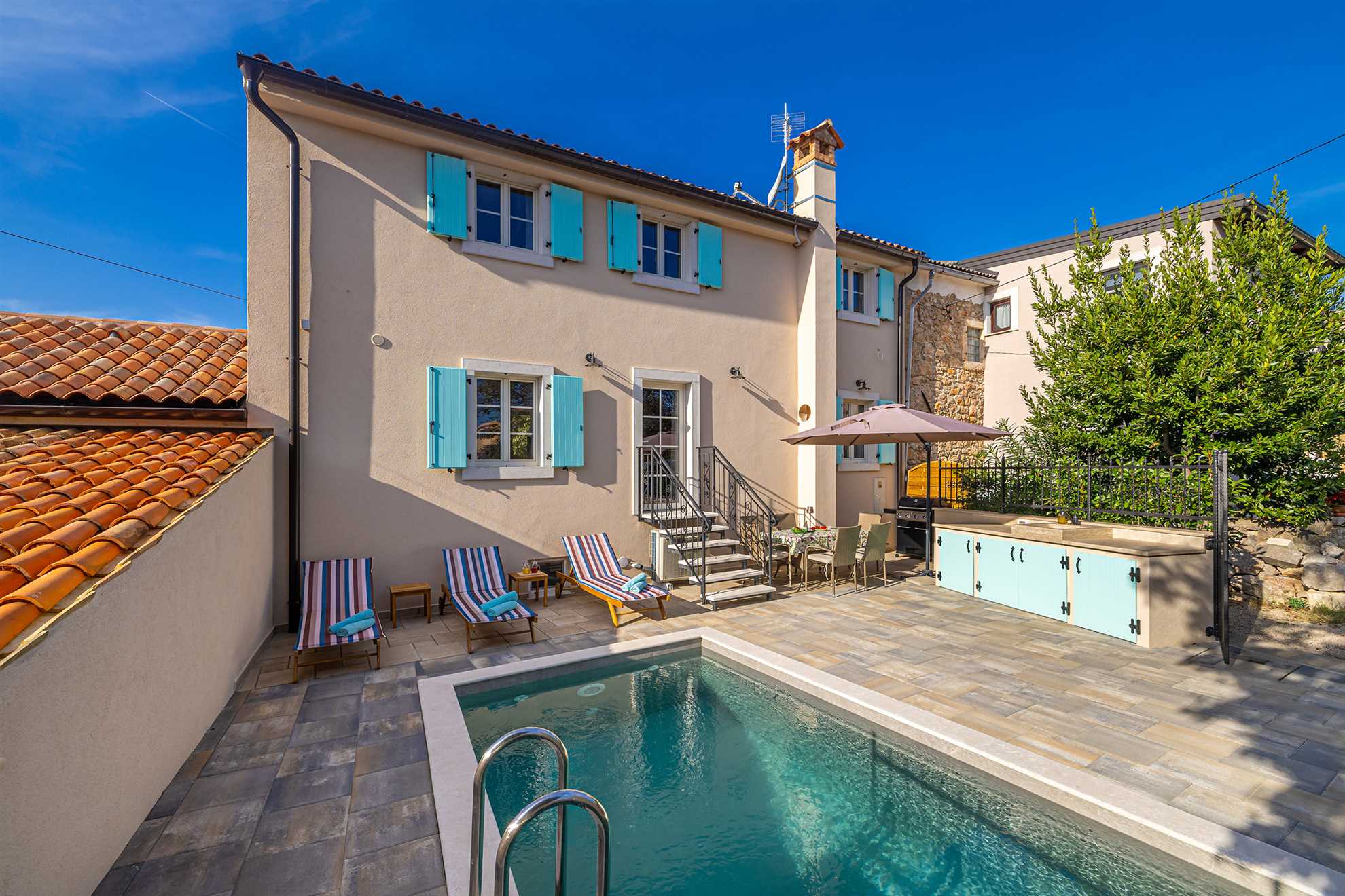 Villa Mavra with a pool and loungers.